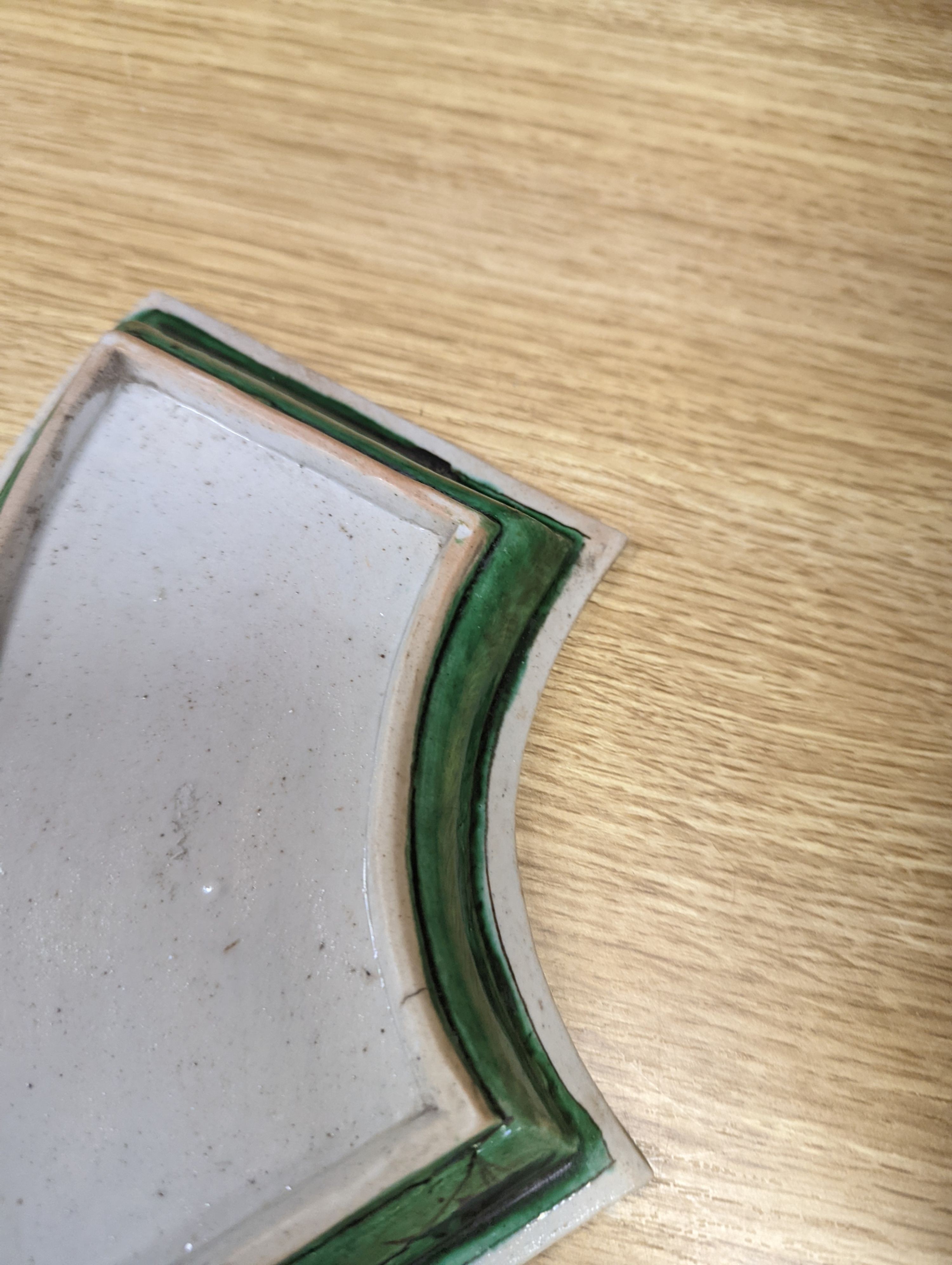 A pair of Chinese famille verte biscuit fan-shaped sweetmeat dishes, Kangxi, 20 cms wide.